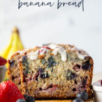 Soft and moist berry banana bread is packed with fresh strawberries, raspberries, and blueberries and topped with a rich cream cheese icing.