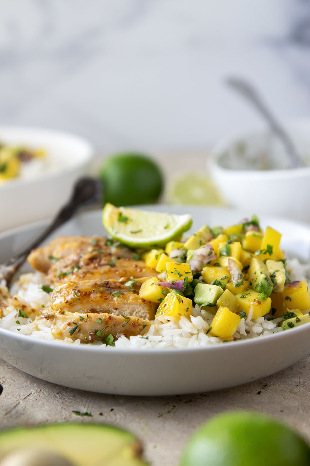 These honey mustard chicken bowls are loaded with so much goodness and you won't believe how quickly they come together! Sweet and tangy honey mustard chicken thighs pair perfectly with fluffy rice and a fresh mango salsa.