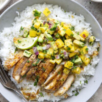 These honey mustard chicken bowls are loaded with so much goodness and you won't believe how quickly they come together! Sweet and tangy honey mustard chicken thighs pair perfectly with fluffy rice and a fresh mango salsa.