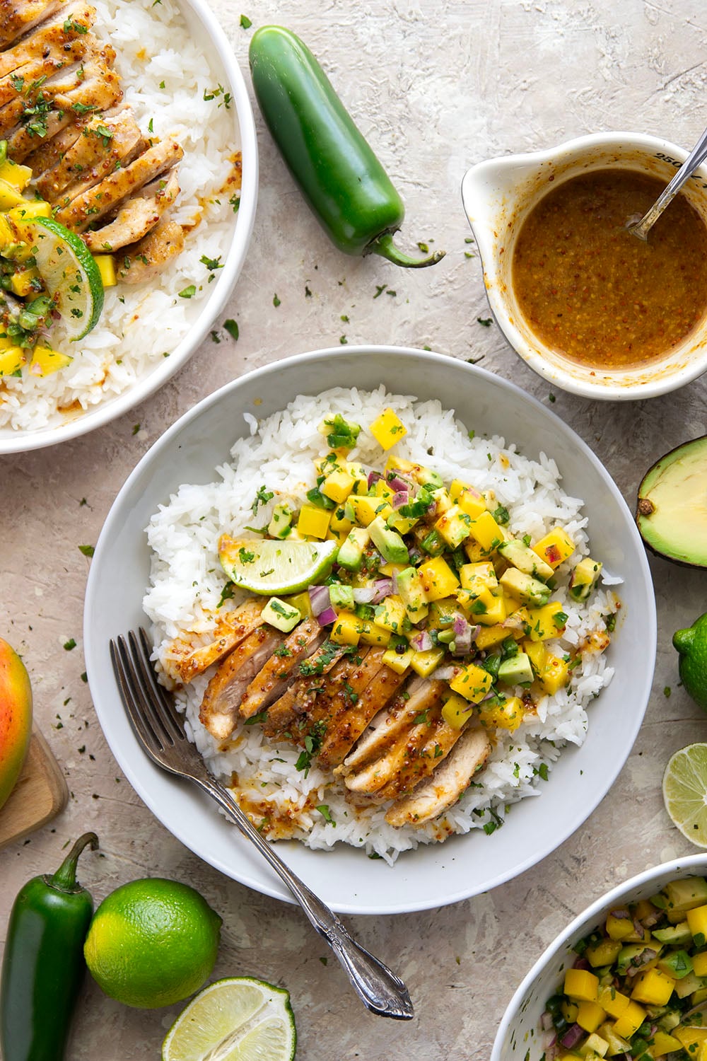 These honey mustard chicken bowls are loaded with so much goodness and you won't believe how quickly they come together! Sweet and tangy honey mustard chicken thighs pair perfectly with fluffy rice and a fresh mango salsa.