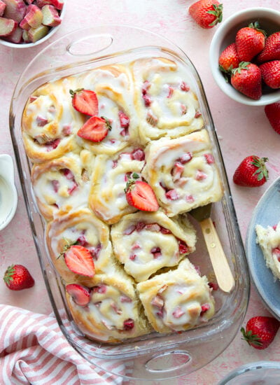 Melt-in-your-mouth fluffy sweet rolls are stuffed with a sweet and tangy rhubarb strawberry filling for the ultimate twist on strawberry sweet rolls!