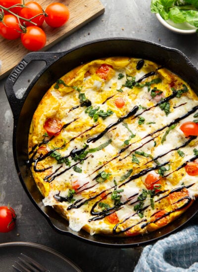 This caprese frittata couldn't be easier to whip up and features a base of fluffy eggs, sweet cherry tomatoes, gooey fresh mozzarella, and lots of fresh basil and balsamic glaze on top.