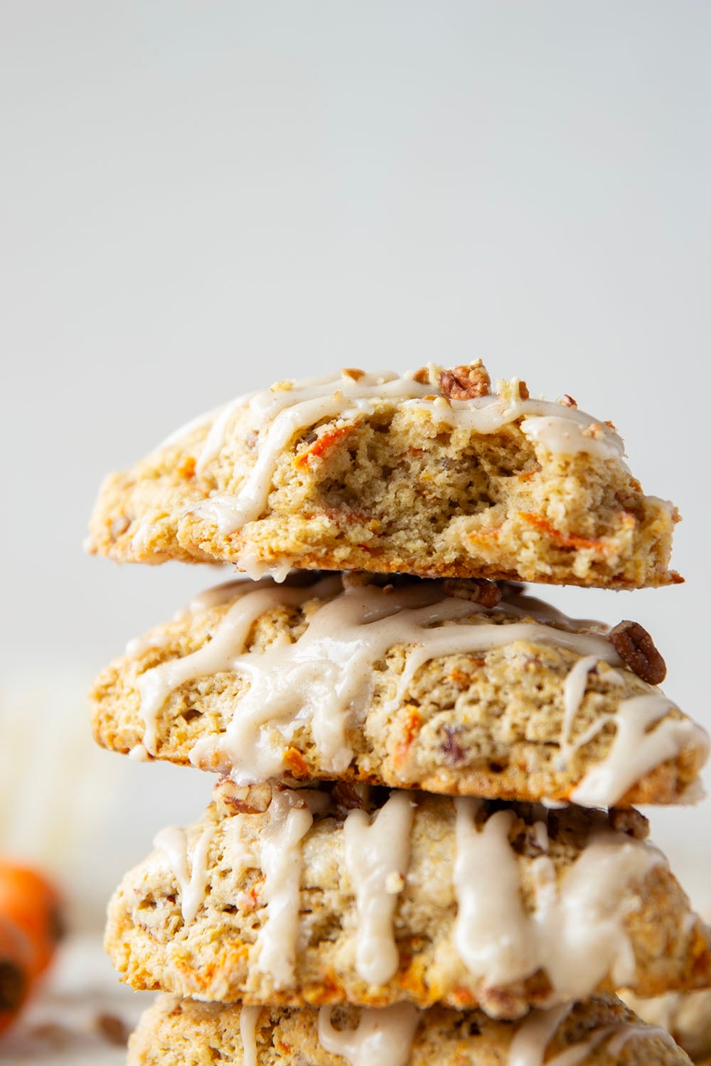 Soft and tender carrot cake scones feature lots of toasted pecans, shredded carrots, and a silky cream cheese glaze drizzled on top.