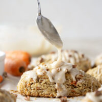 Soft and tender carrot cake scones feature lots of toasted pecans, shredded carrots, and a silky cream cheese glaze drizzled on top.