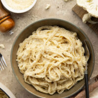 Indulge in a creamy, silky alfredo sauce for a fraction of the calories in this cauliflower alfredo sauce version! NO heavy cream needed and it's made in minutes on the stovetop.