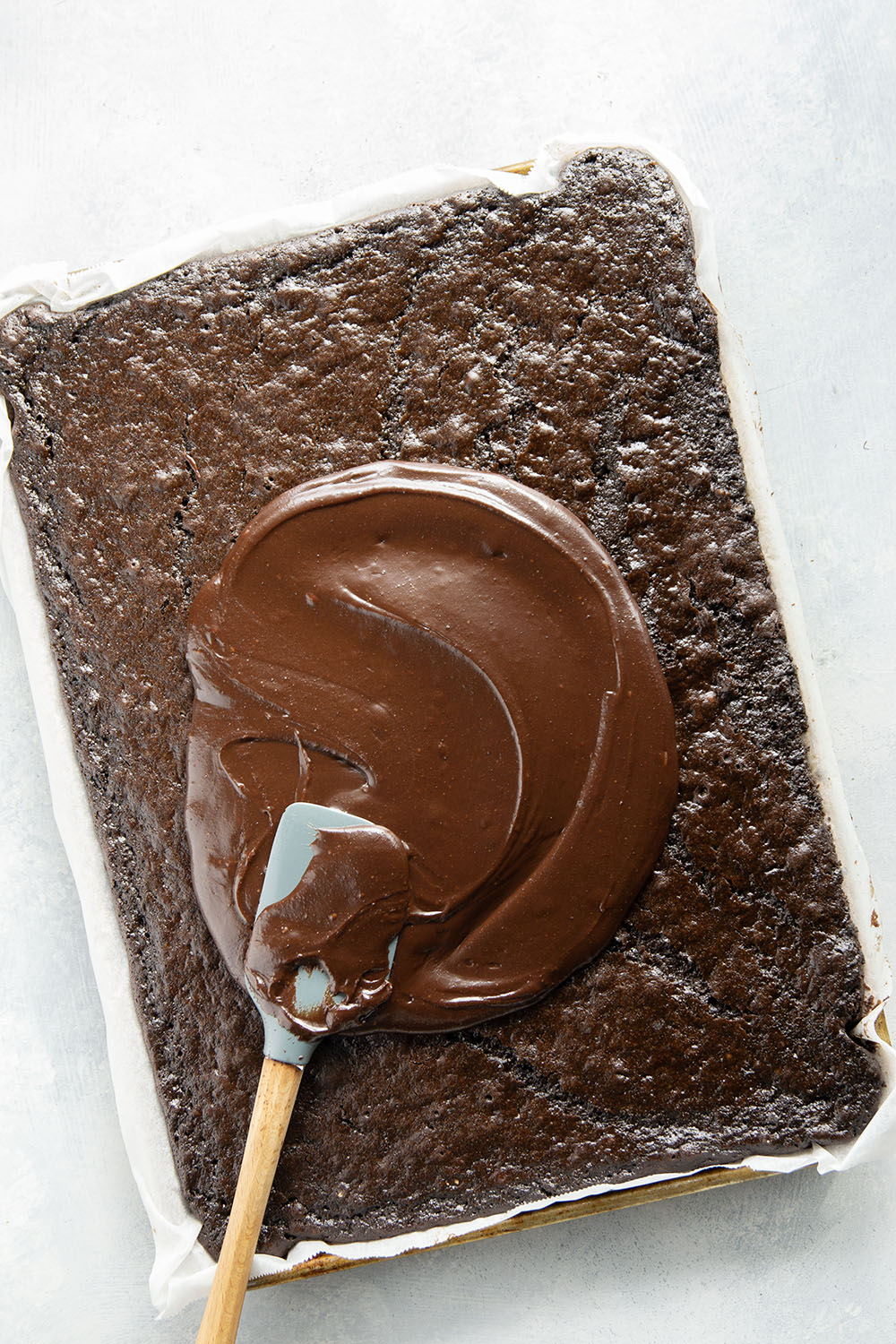 This classic chocolate sheet cake is always a hit at parties! Supremely moist, heavy on the chocolate, and frosted in a silky chocolate fudge frosting.