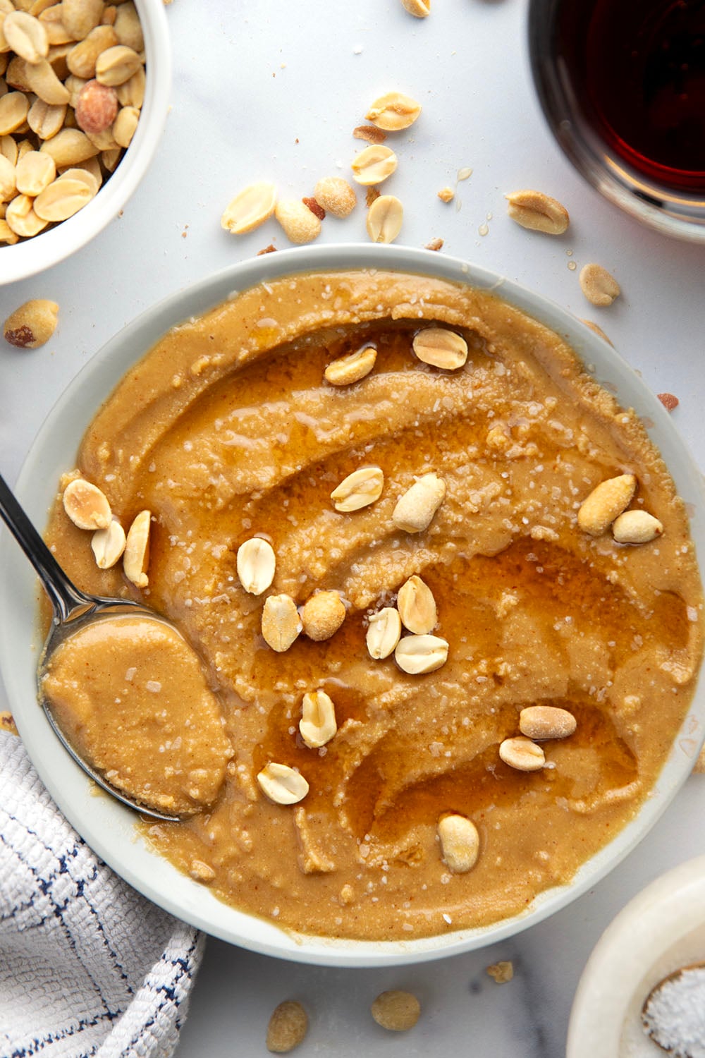 You'll never go back to jarred peanut butter after one taste of this smooth, creamy homemade maple peanut butter, that's lightly flavored with maple syrup, vanilla, and a touch of cinnamon.