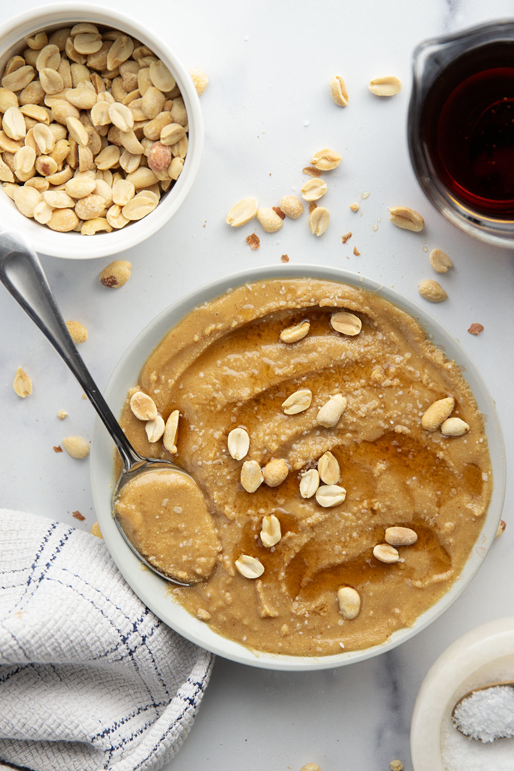 You'll never go back to jarred peanut butter after one taste of this smooth, creamy homemade maple peanut butter, that's lightly flavored with maple syrup, vanilla, and a touch of cinnamon.
