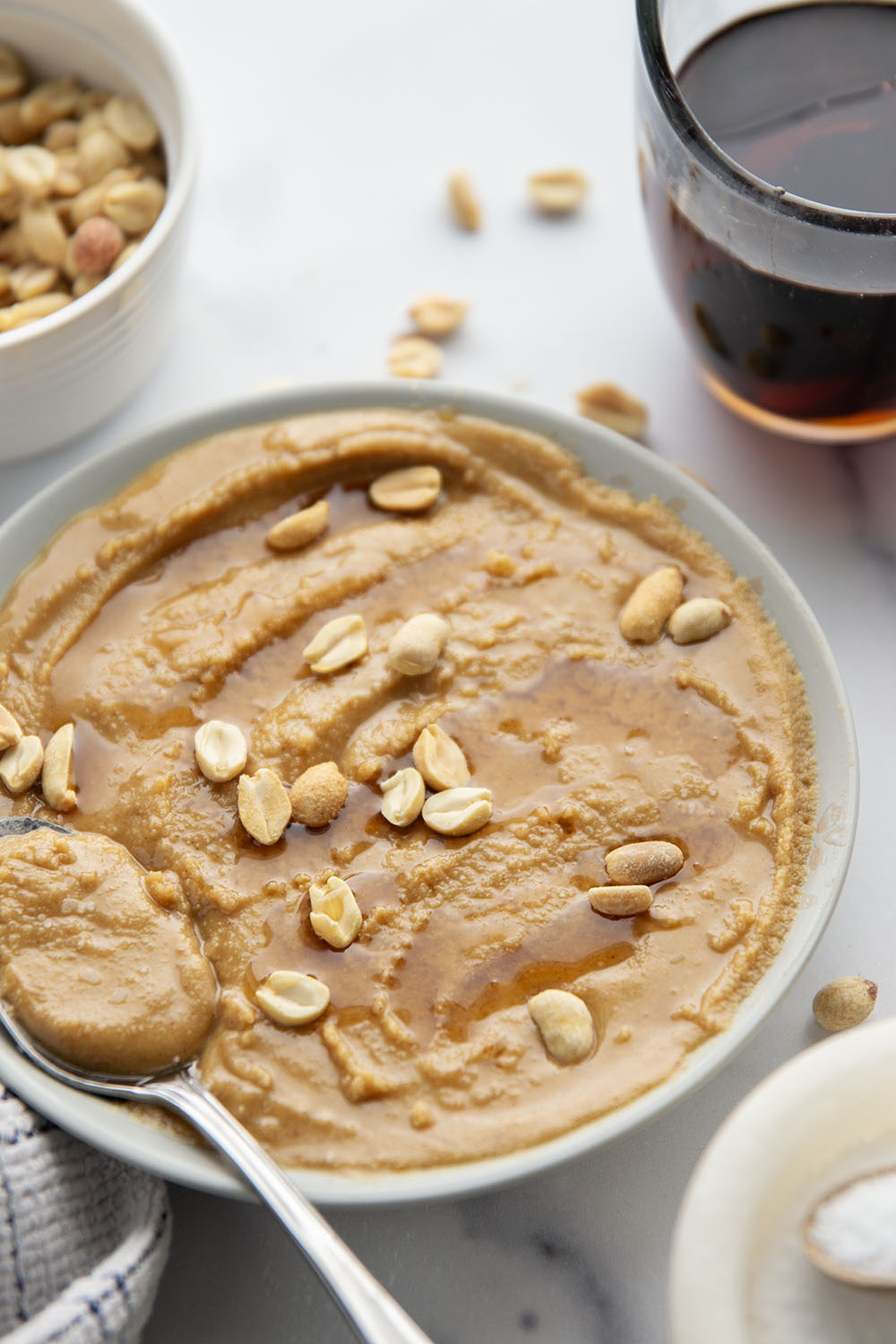 You'll never go back to jarred peanut butter after one taste of this smooth, creamy homemade maple peanut butter, that's lightly flavored with maple syrup, vanilla, and a touch of cinnamon.