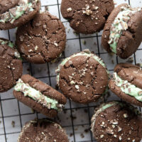 These mint chocolate sandwich cookies feature rich chocolate cookies with a creamy mint buttercream sandwiched between and rolled in lots of chopped Andes candies.