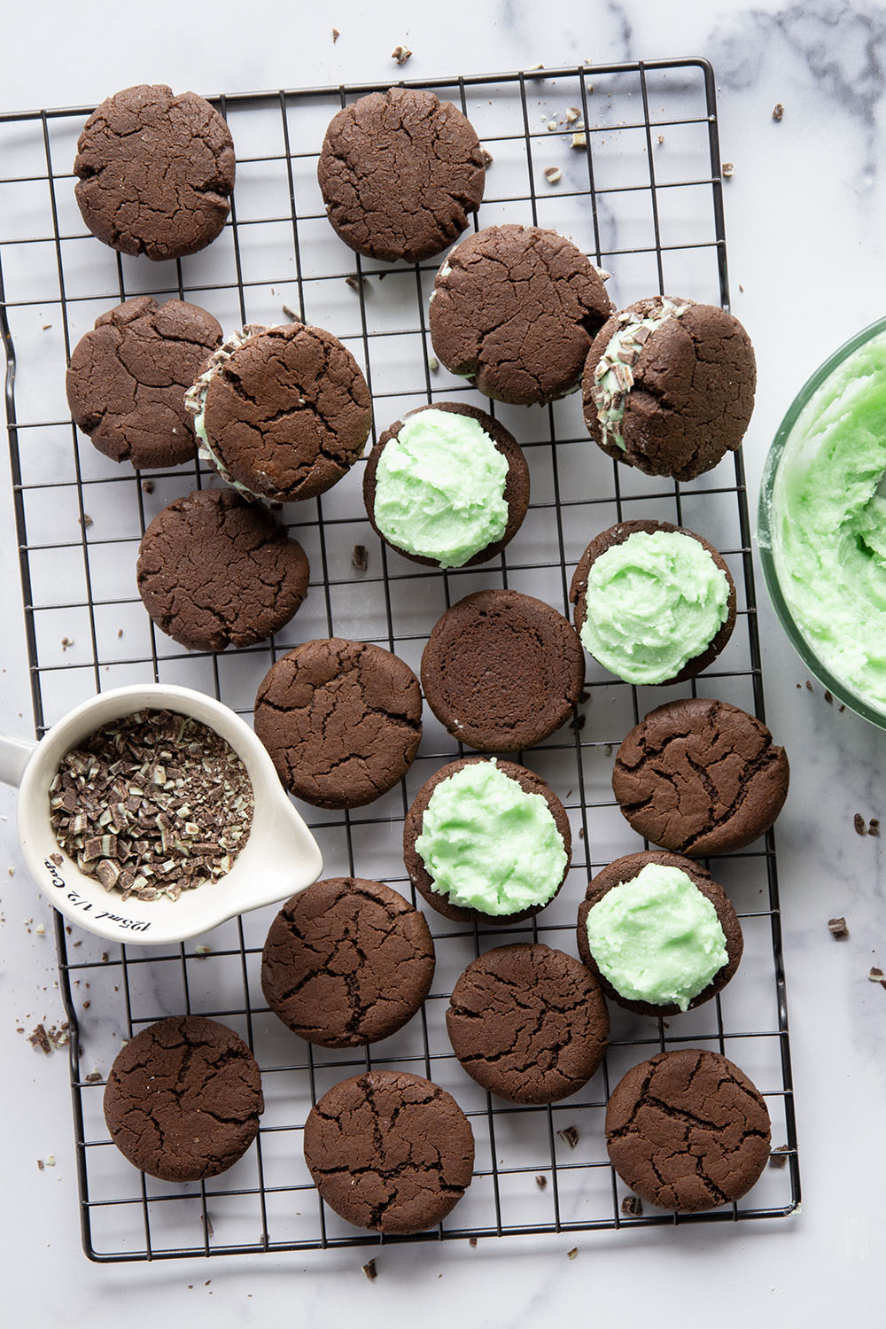 These mint chocolate sandwich cookies feature rich chocolate cookies with a creamy mint buttercream sandwiched between and rolled in lots of chopped Andes candies.