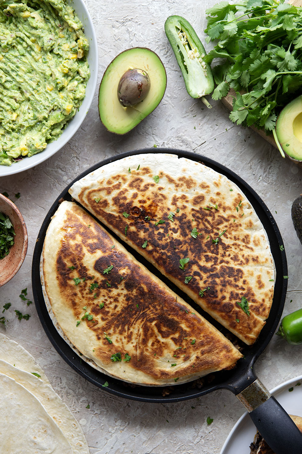 These ground beef quesadillas feature a cheesy ground beef black bean filling and lots of sweet corn guacamole for dipping.