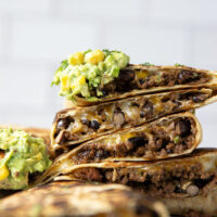 These ground beef quesadillas feature a cheesy ground beef black bean filling and lots of sweet corn guacamole for dipping.