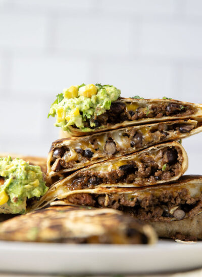 These ground beef quesadillas feature a cheesy ground beef black bean filling and lots of sweet corn guacamole for dipping.