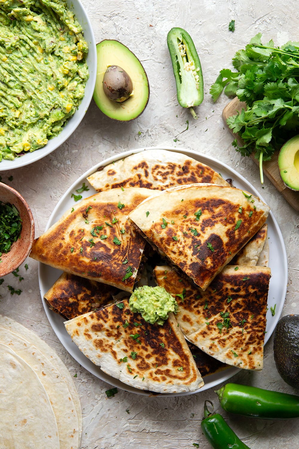 These ground beef quesadillas feature a cheesy ground beef black bean filling and lots of sweet corn guacamole for dipping.