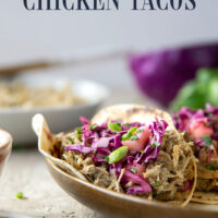 Spicy slow-cooked jerk chicken tacos feature fall-apart tender chicken cooked in a spicy homemade jerk sauce and topped with a fresh pineapple slaw.