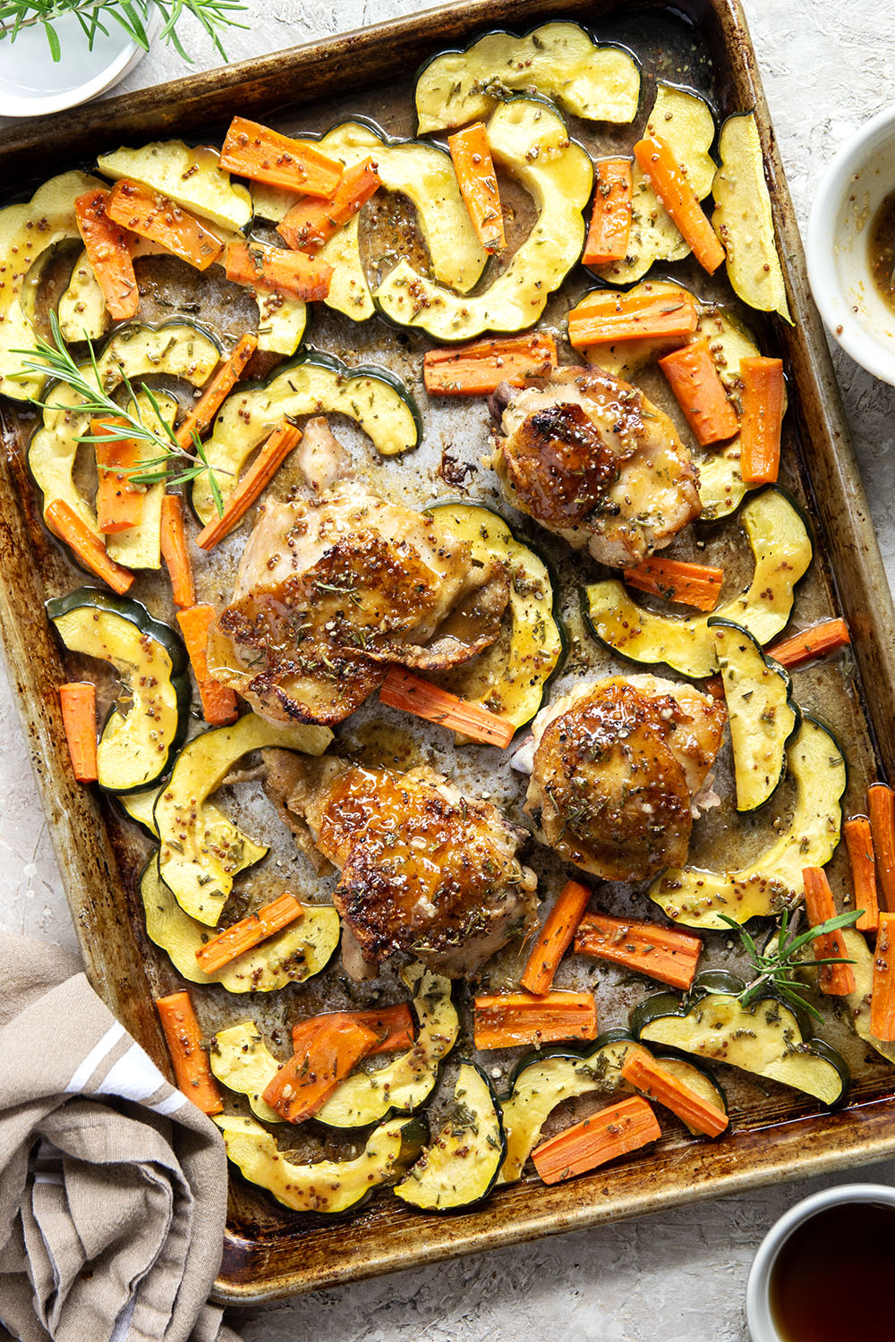 Baked in a sweet and flavorful maple dijon sauce with tender fall veggies, these maple dijon chicken thighs are a quick weeknight dinner that everyone always loves!