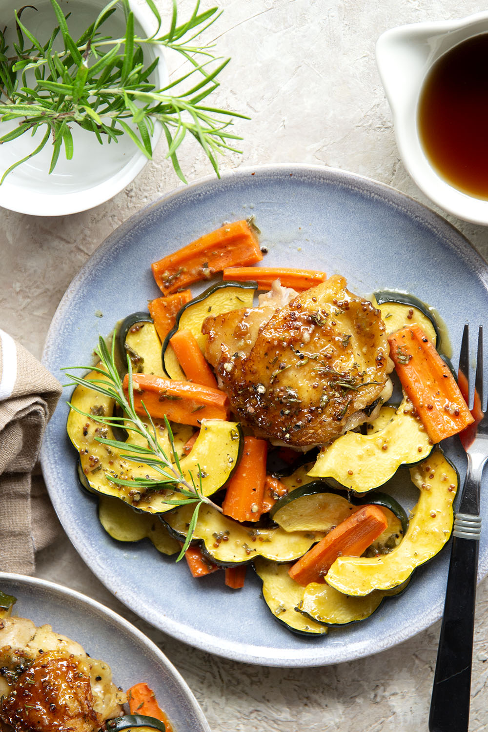 Baked in a sweet and flavorful maple dijon sauce with tender fall veggies, these maple dijon chicken thighs are a quick weeknight dinner that everyone always loves!
