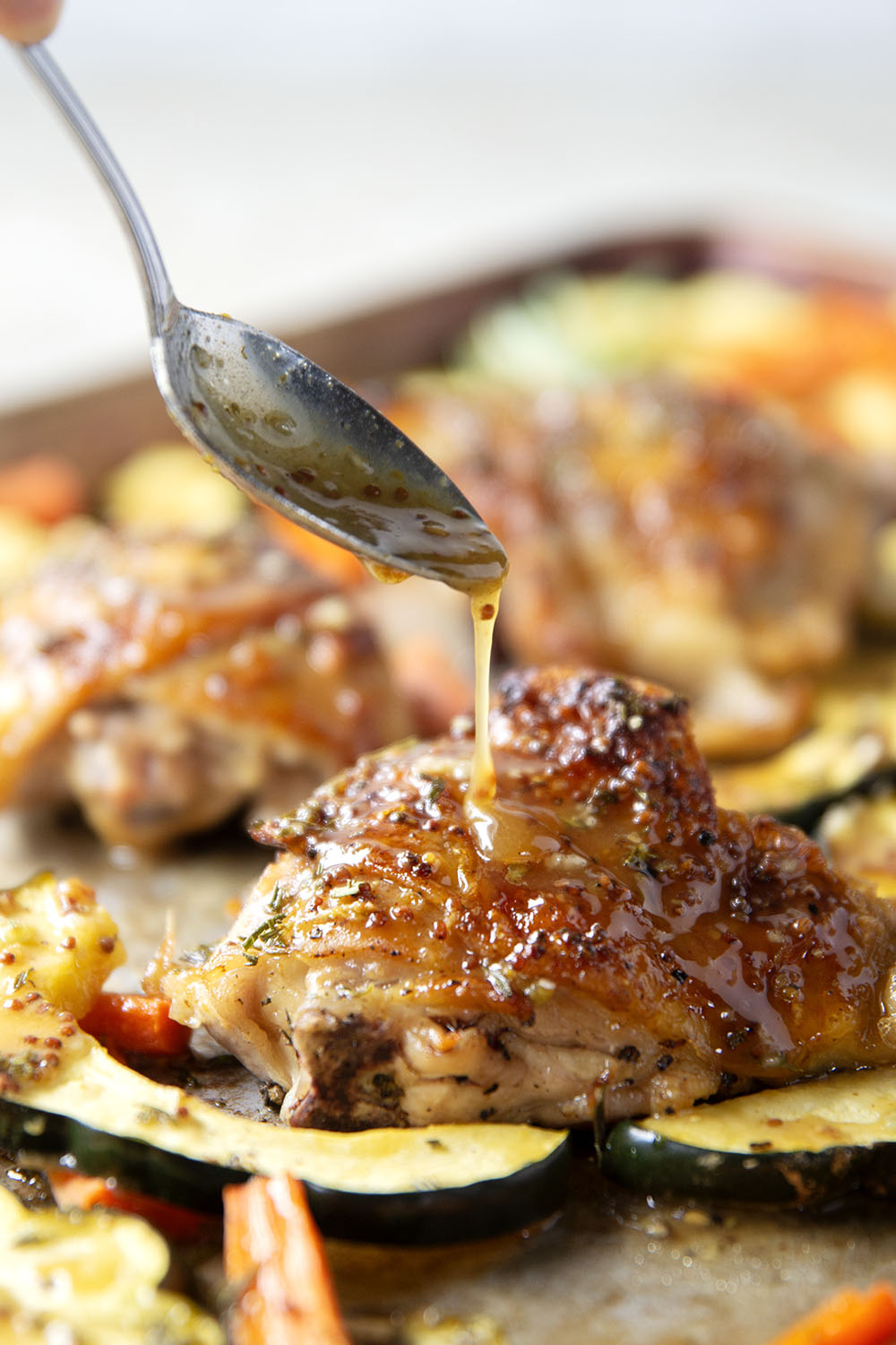 Baked in a sweet and flavorful maple dijon sauce with tender fall veggies, these maple dijon chicken thighs are a quick weeknight dinner that everyone always loves!