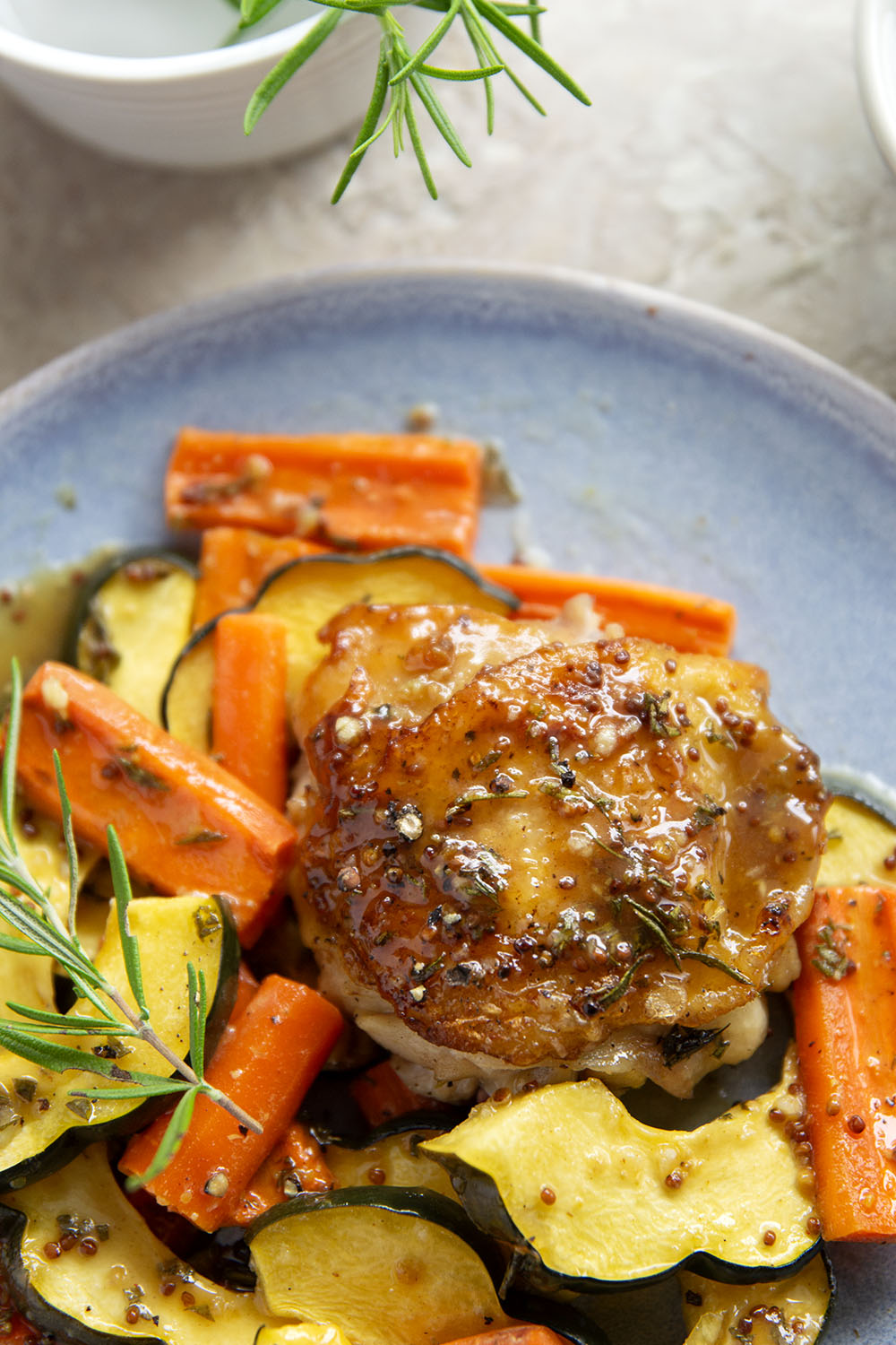 Baked in a sweet and flavorful maple dijon sauce with tender fall veggies, these maple dijon chicken thighs are a quick weeknight dinner that everyone always loves!