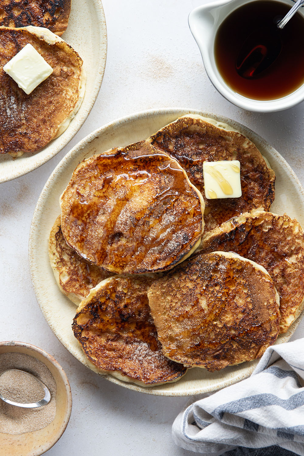 Love snickerdoodle cookies? You'll adore these snickerdoodle pancakes that feature a fluffy buttermilk pancake base with cinnamon sugar caramelized on the outside.