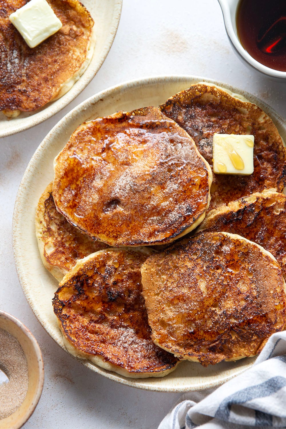 Love snickerdoodle cookies? You'll adore these snickerdoodle pancakes that feature a fluffy buttermilk pancake base with cinnamon sugar caramelized on the outside.