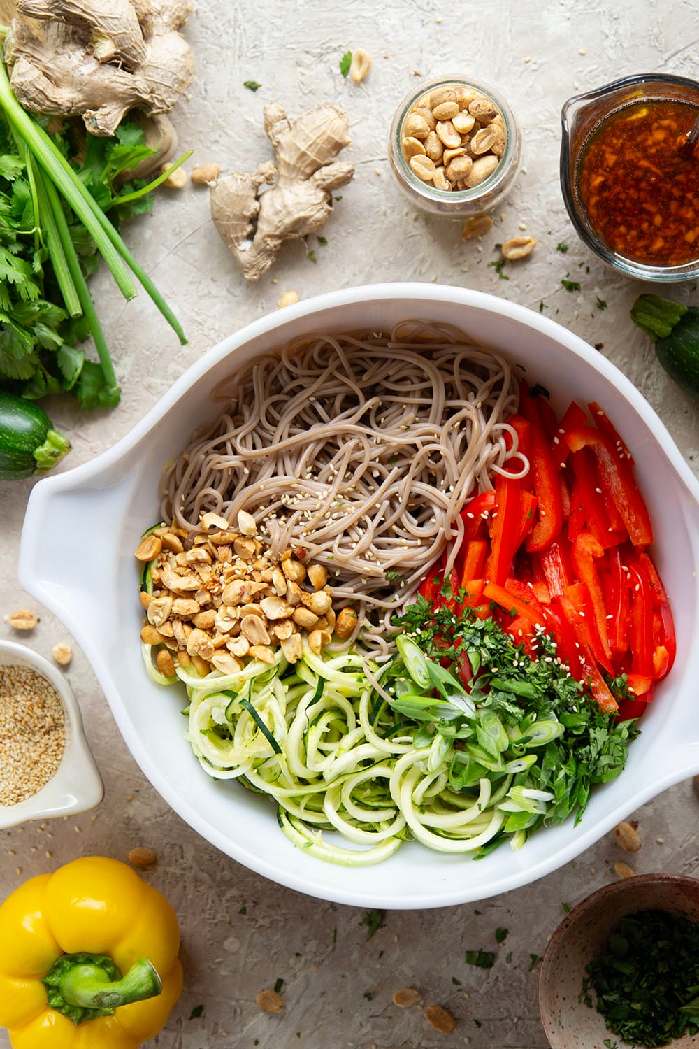 Zucchini and soba noodles are the perfect salad base in this zucchini soba noodle salad that features crunchy sweet peppers, lots of fresh herbs, and a flavorful fresh ginger sesame dressing.
