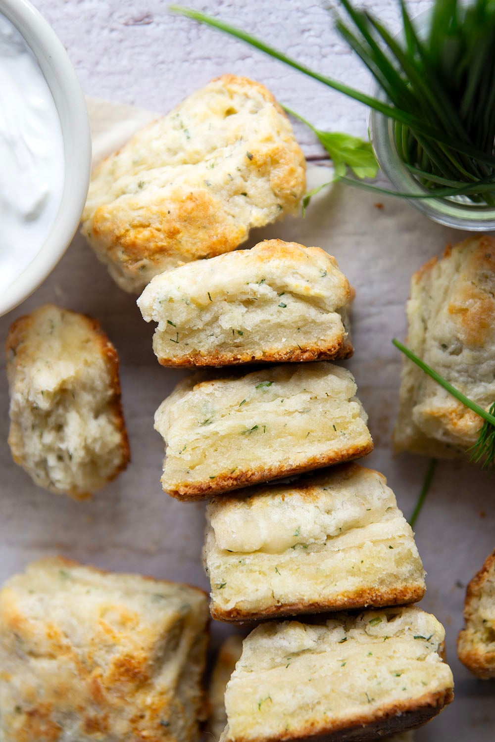 Fresh herbs and tangy Greek yogurt are a match made in heaven in these flaky Greek yogurt biscuits! Crack them open warm from the oven and top with lots of butter.
