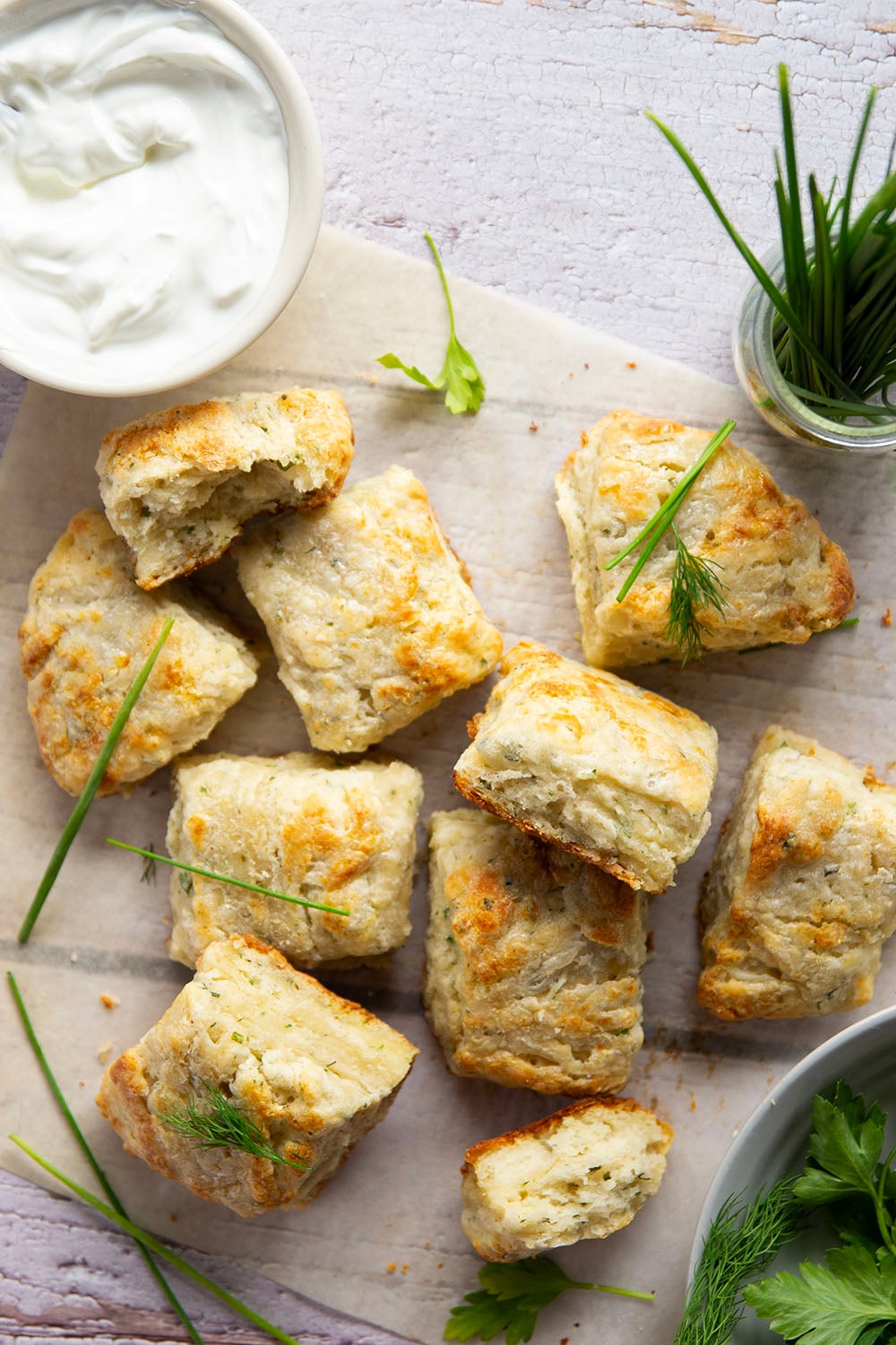 Fresh herbs and tangy Greek yogurt are a match made in heaven in these flaky Greek yogurt biscuits! Crack them open warm from the oven and top with lots of butter.
