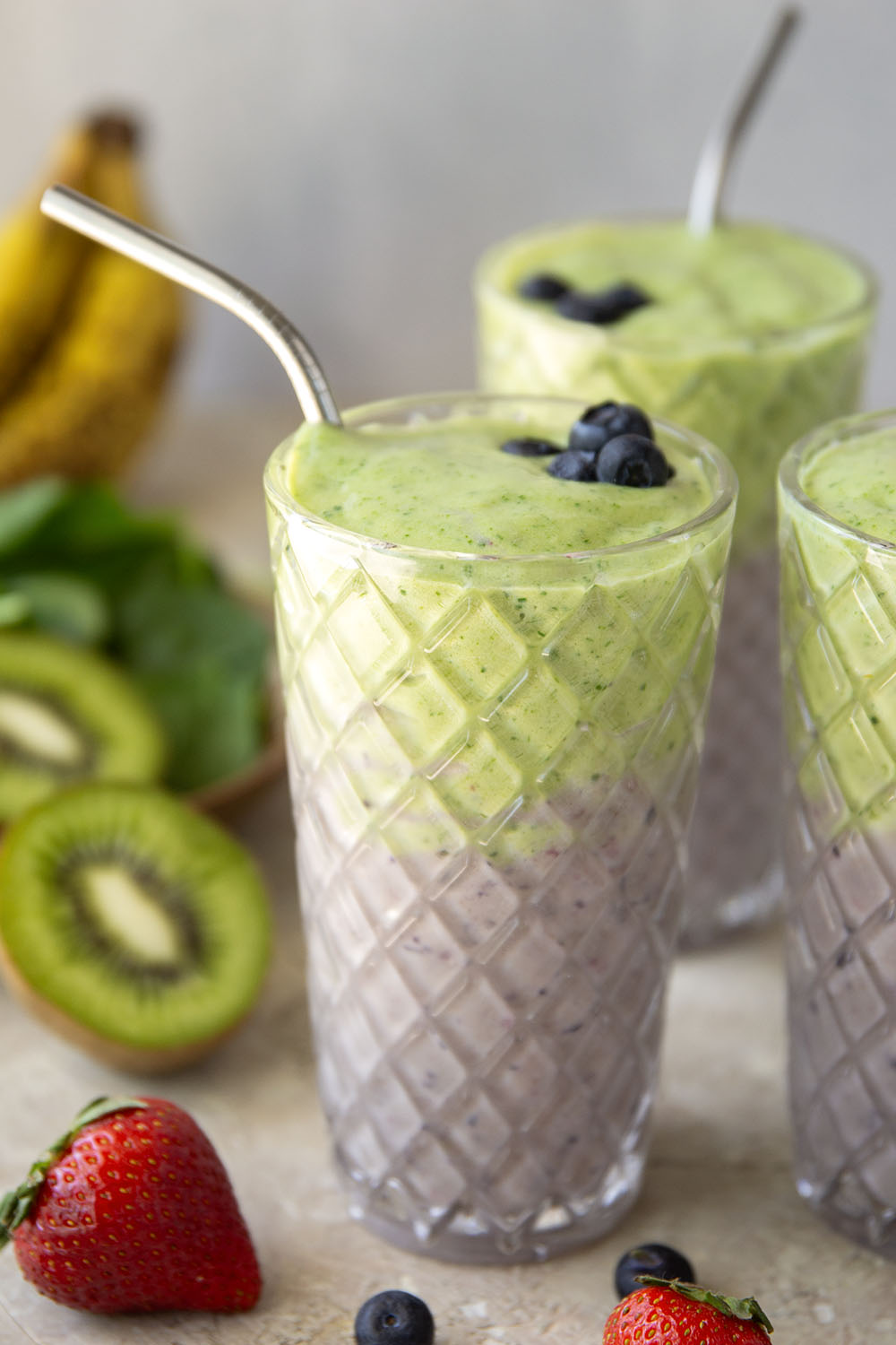 A double layer of mixed berries and vibrant green ingredients comes together in this protein-packed berry green smoothie that you can feel good about sipping!