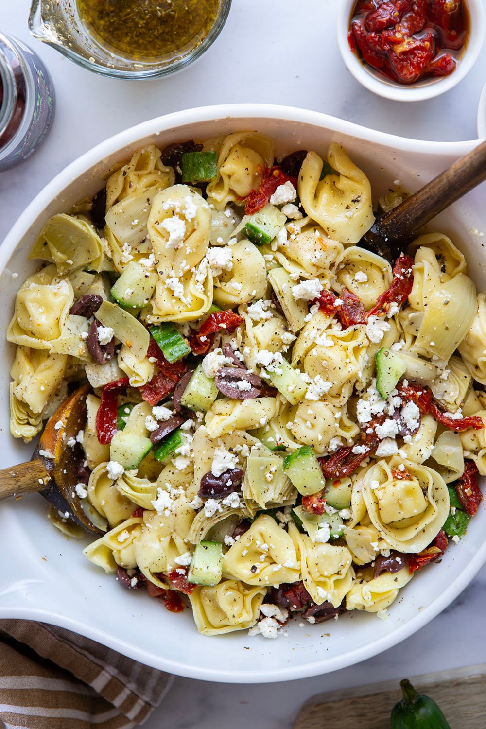 Bring this fresh Mediterranean tortellini pasta salad to any picnic and watch it disappear! Loaded with a rainbow of Mediterranean ingredients and tossed in a tangy white wine vinaigrette.
