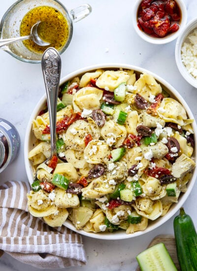 Bring this fresh Mediterranean tortellini pasta salad to any picnic and watch it disappear! Loaded with a rainbow of Mediterranean ingredients and tossed in a tangy white wine vinaigrette.