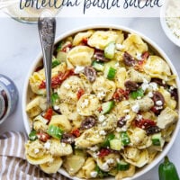 Bring this fresh Mediterranean tortellini pasta salad to any picnic and watch it disappear! Loaded with a rainbow of Mediterranean ingredients and tossed in a tangy white wine vinaigrette.