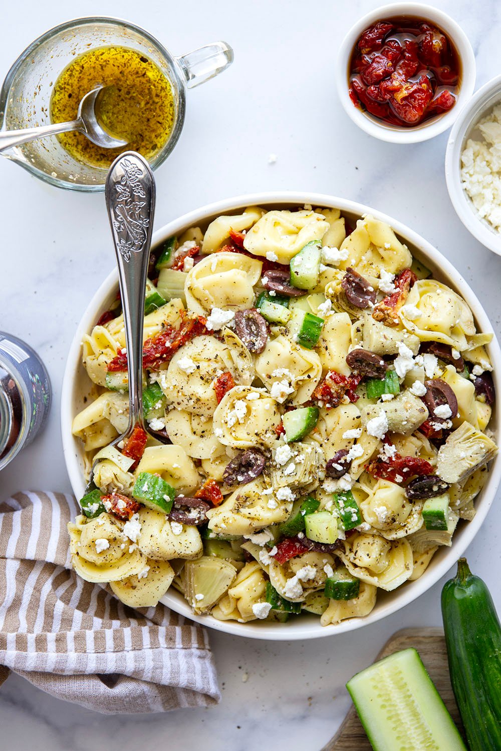 Bring this fresh Mediterranean tortellini pasta salad to any picnic and watch it disappear! Loaded with a rainbow of Mediterranean ingredients and tossed in a tangy white wine vinaigrette.