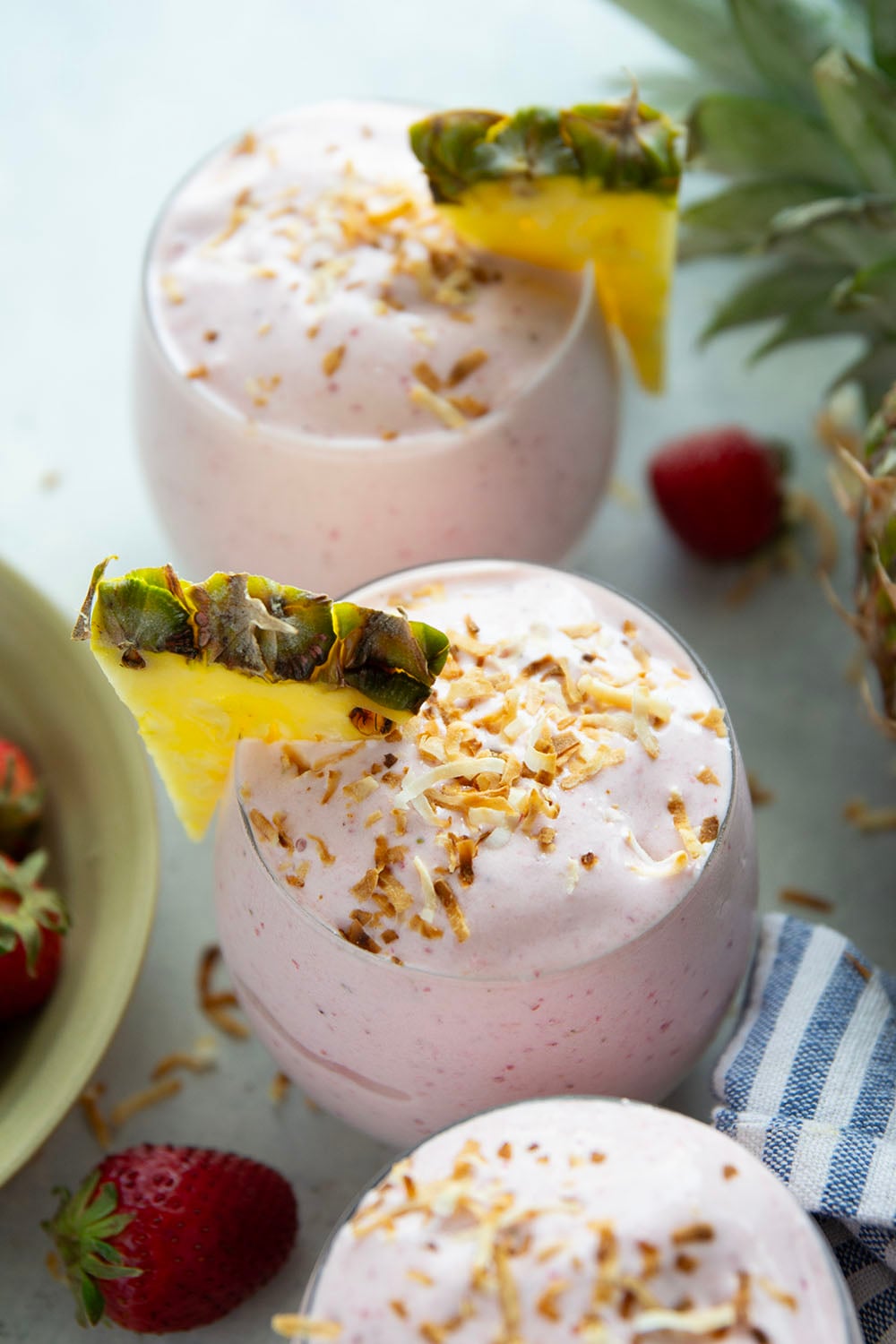 This creamy pina colada smoothie will make you feel like you took a trip to the tropics! Packed with lots of fruit, coconut flavor, and a big protein boost as well.