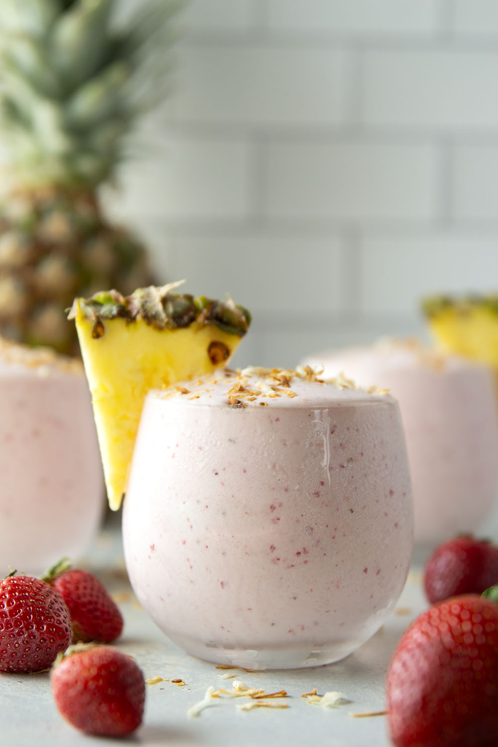 This creamy pina colada smoothie will make you feel like you took a trip to the tropics! Packed with lots of fruit, coconut flavor, and a big protein boost as well.