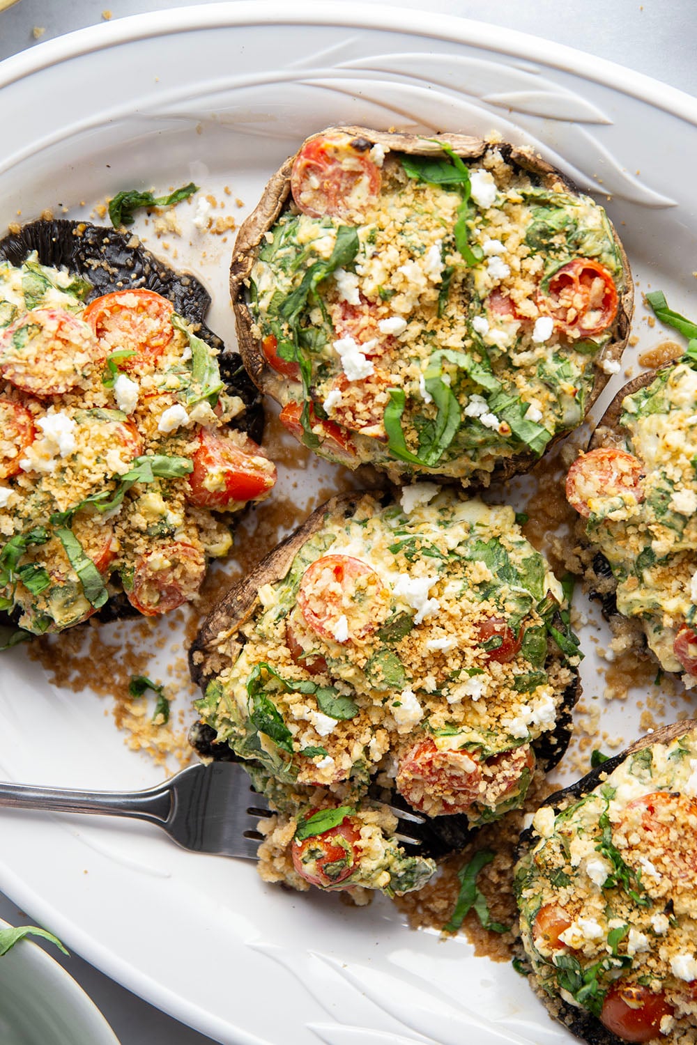 These stuffed portobello mushrooms include a fresh cherry tomato spinach feta filling stuffed into tender portobello caps and grilled for just a few minutes until perfectly tender and smoky.