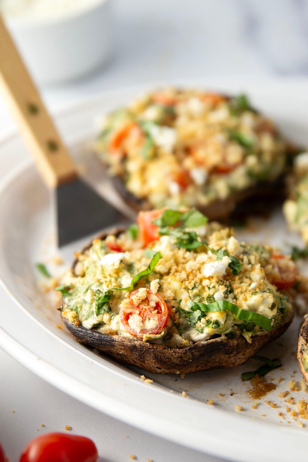 These stuffed portobello mushrooms include a fresh cherry tomato spinach feta filling stuffed into tender portobello caps and grilled for just a few minutes until perfectly tender and smoky.