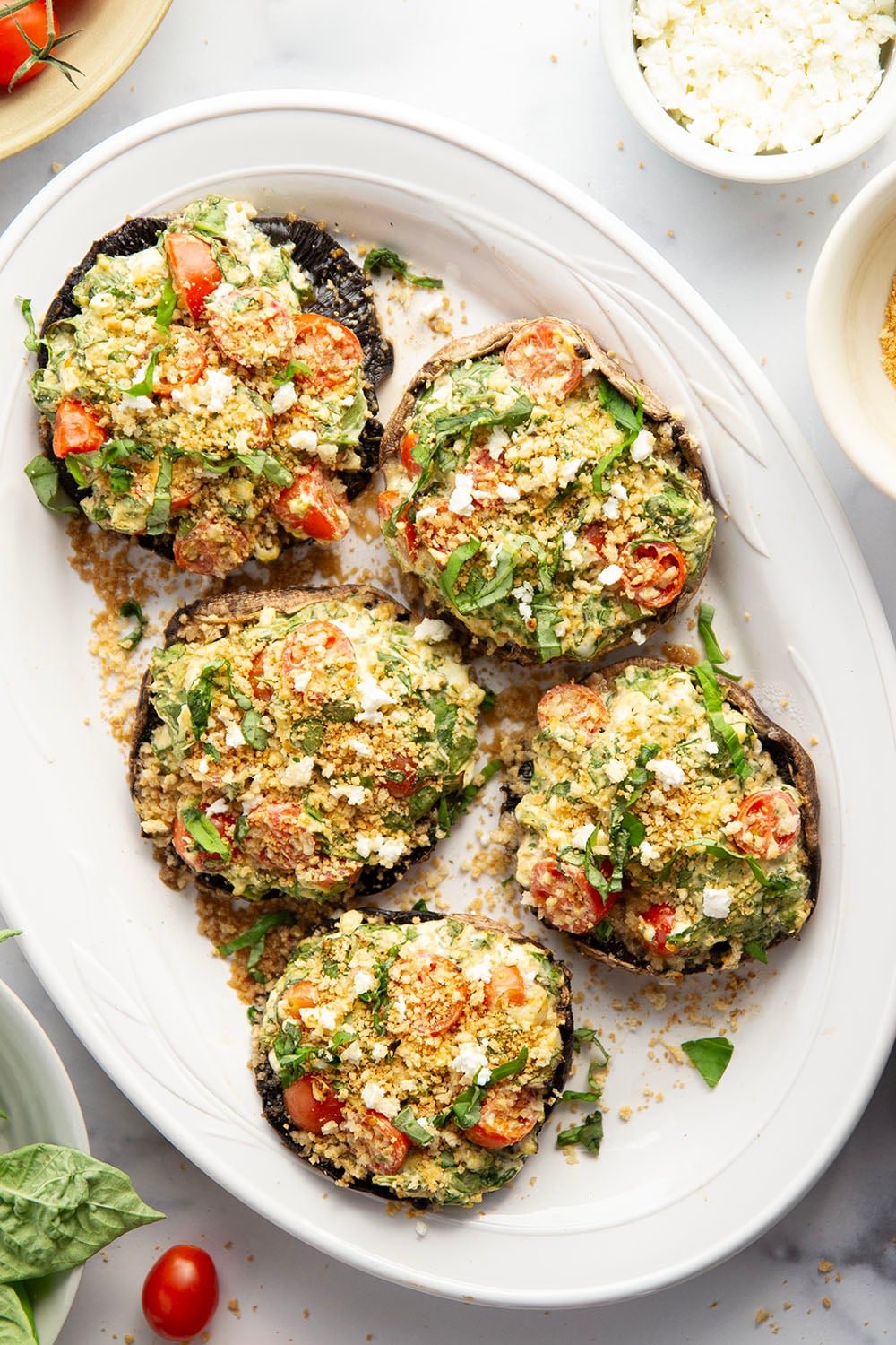 These stuffed portobello mushrooms include a fresh cherry tomato spinach feta filling stuffed into tender portobello caps and grilled for just a few minutes until perfectly tender and smoky.