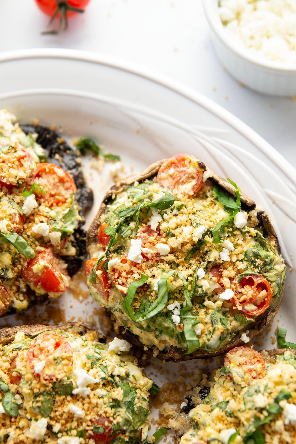 These stuffed portobello mushrooms include a fresh cherry tomato spinach feta filling stuffed into tender portobello caps and grilled for just a few minutes until perfectly tender and smoky.