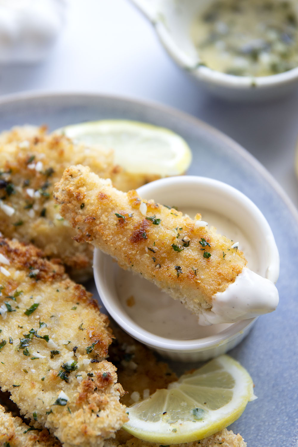 Oven fried to perfection until perfectly crispy and drizzled with a fresh lemon garlic butter, these lemon chicken tenders are always a dinner favorite.