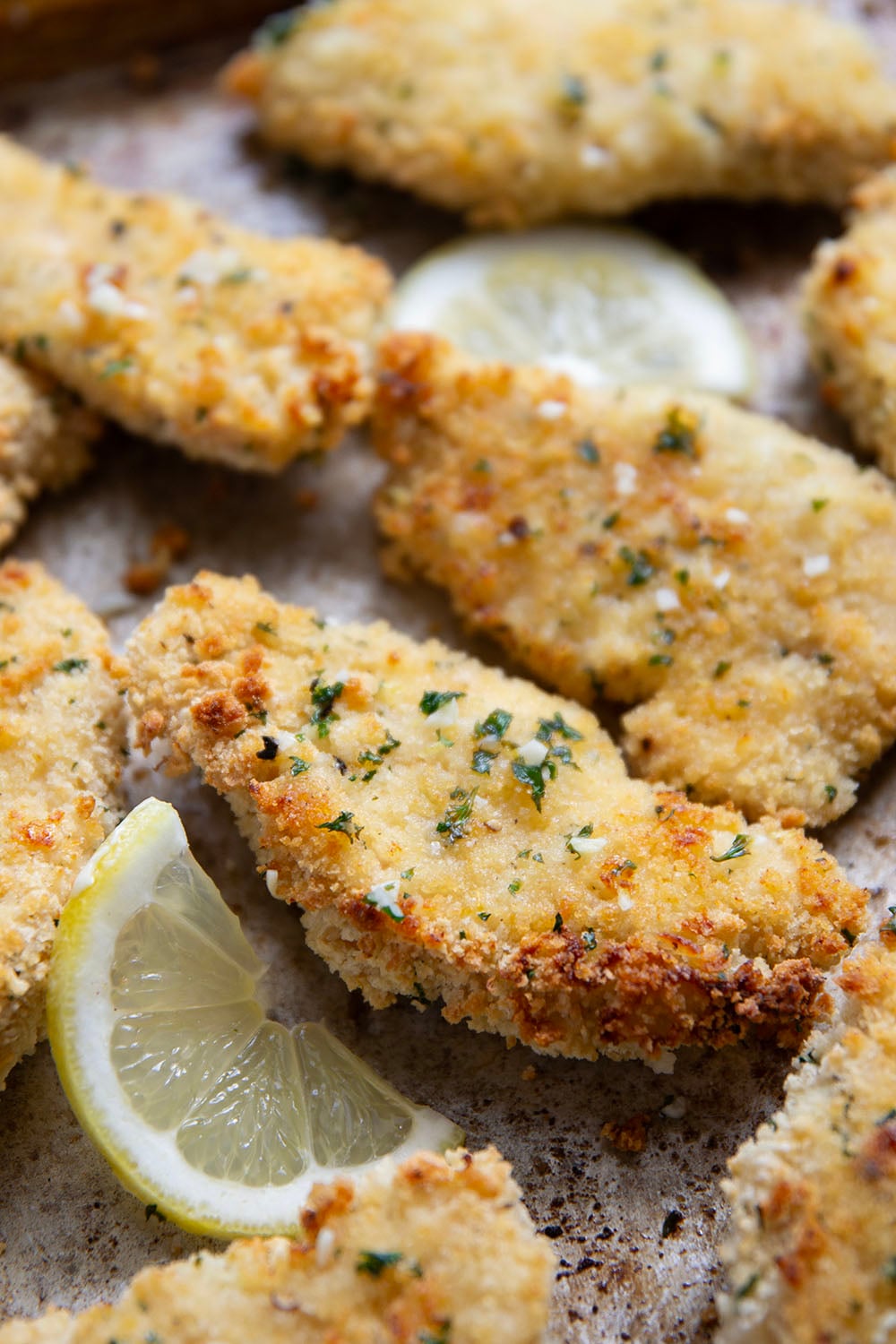 Oven fried to perfection until perfectly crispy and drizzled with a fresh lemon garlic butter, these lemon chicken tenders are always a dinner favorite.