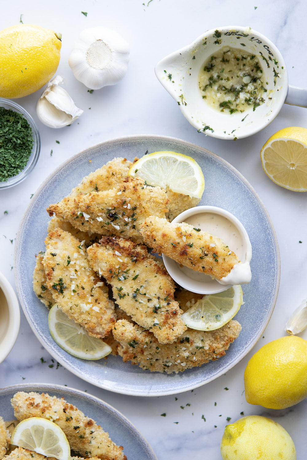 Oven fried to perfection until perfectly crispy and drizzled with a fresh lemon garlic butter, these lemon chicken tenders are always a dinner favorite.