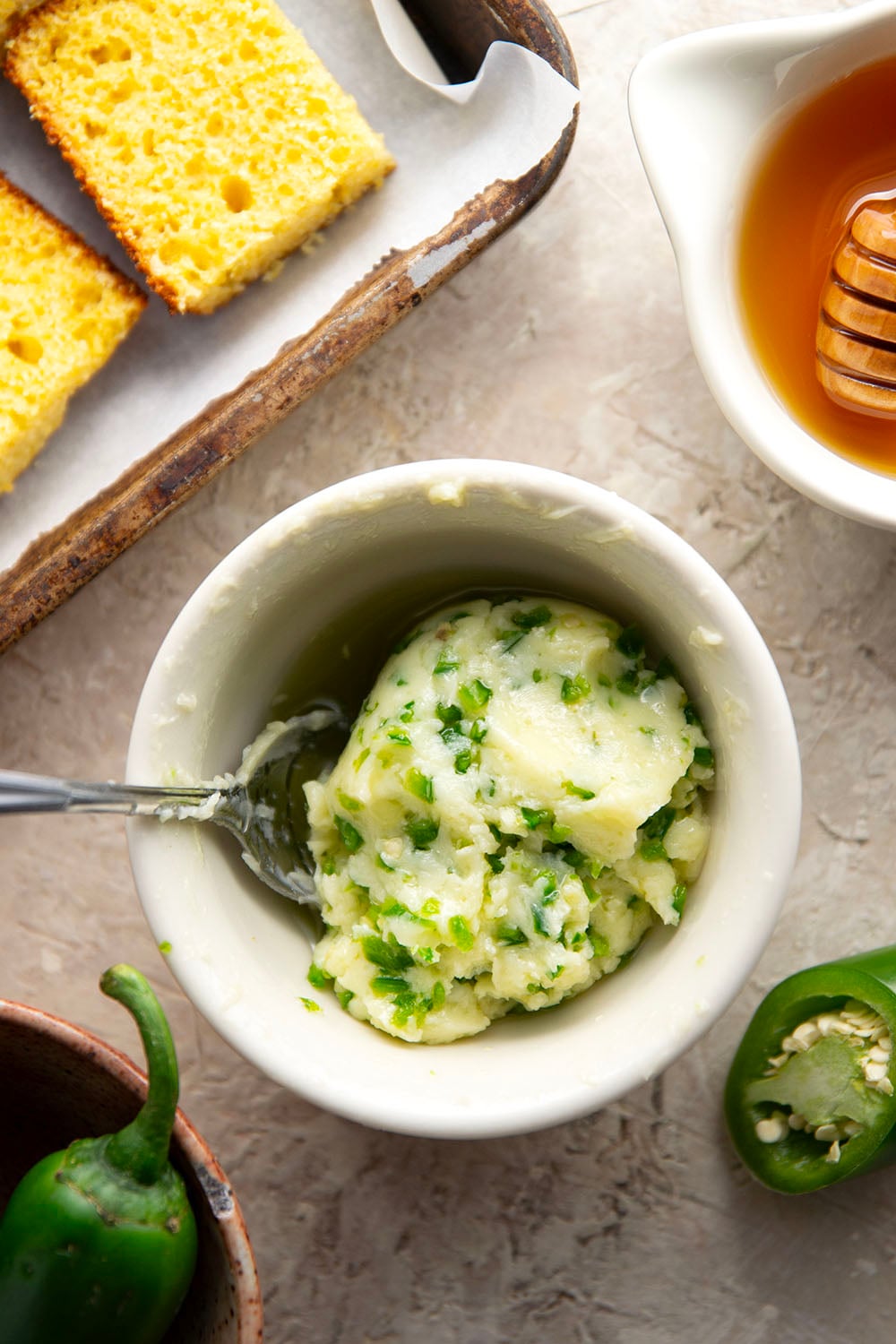 This grilled cornbread features homemade cornbread squares spread with a spicy jalapeno honey butter and then quickly cooked on the grill until perfectly crispy!