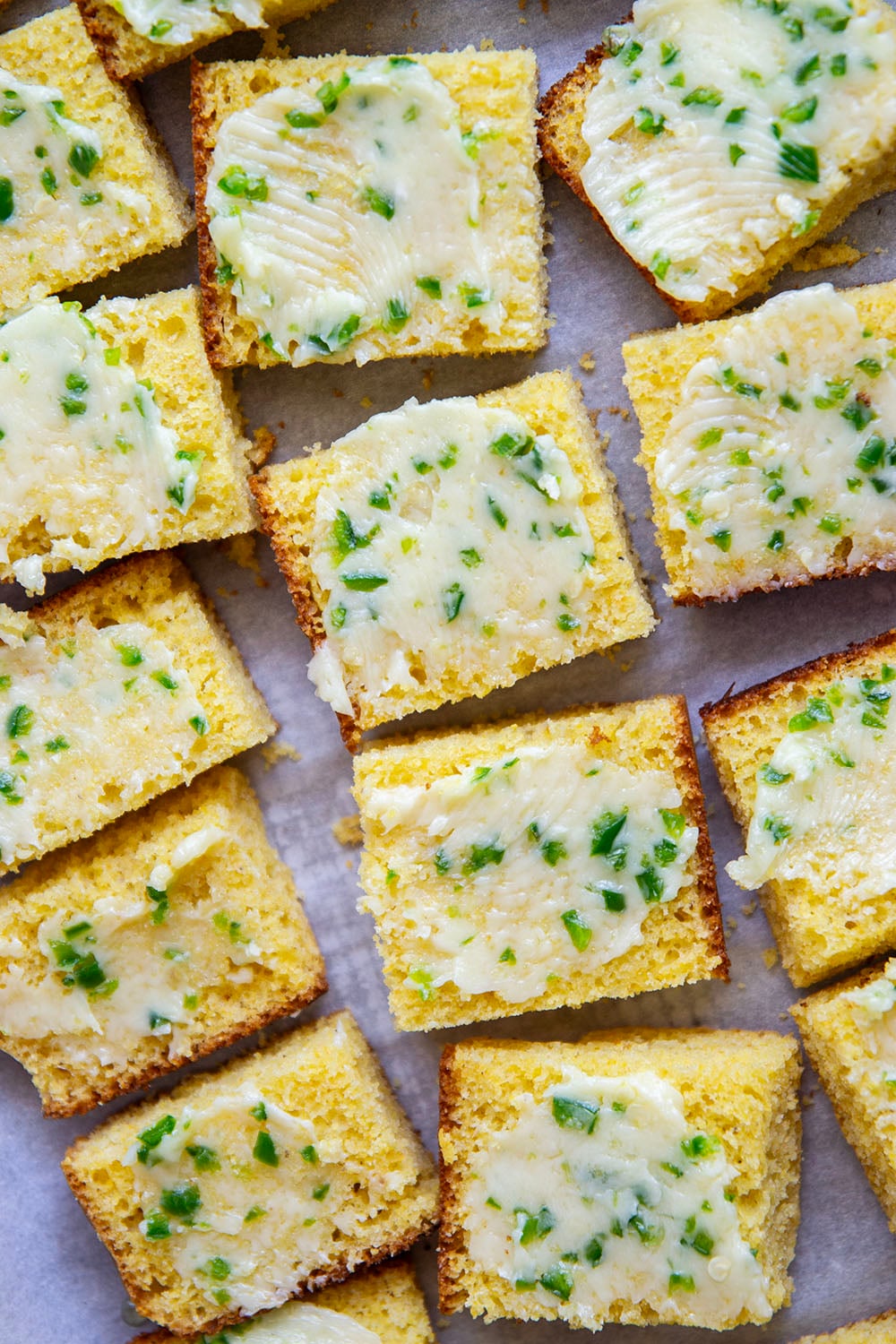 This grilled cornbread features homemade cornbread squares spread with a spicy jalapeno honey butter and then quickly cooked on the grill until perfectly crispy!