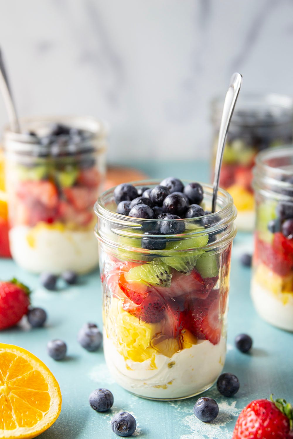 Take your fruit salad along to those summer picnics the easy way! Layer it up rainbow-style in a jar with a creamy citrus yogurt dressing. This layered fruit salad will quickly become a summer favorite.