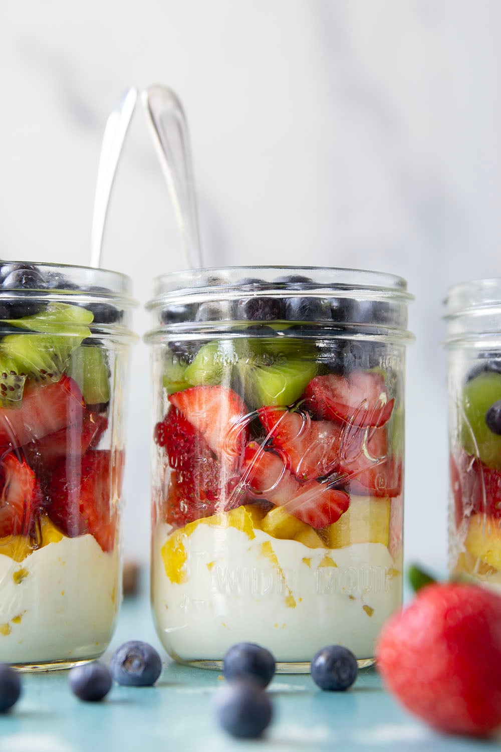 Take your fruit salad along to those summer picnics the easy way! Layer it up rainbow-style in a jar with a creamy citrus yogurt dressing. This layered fruit salad will quickly become a summer favorite.
