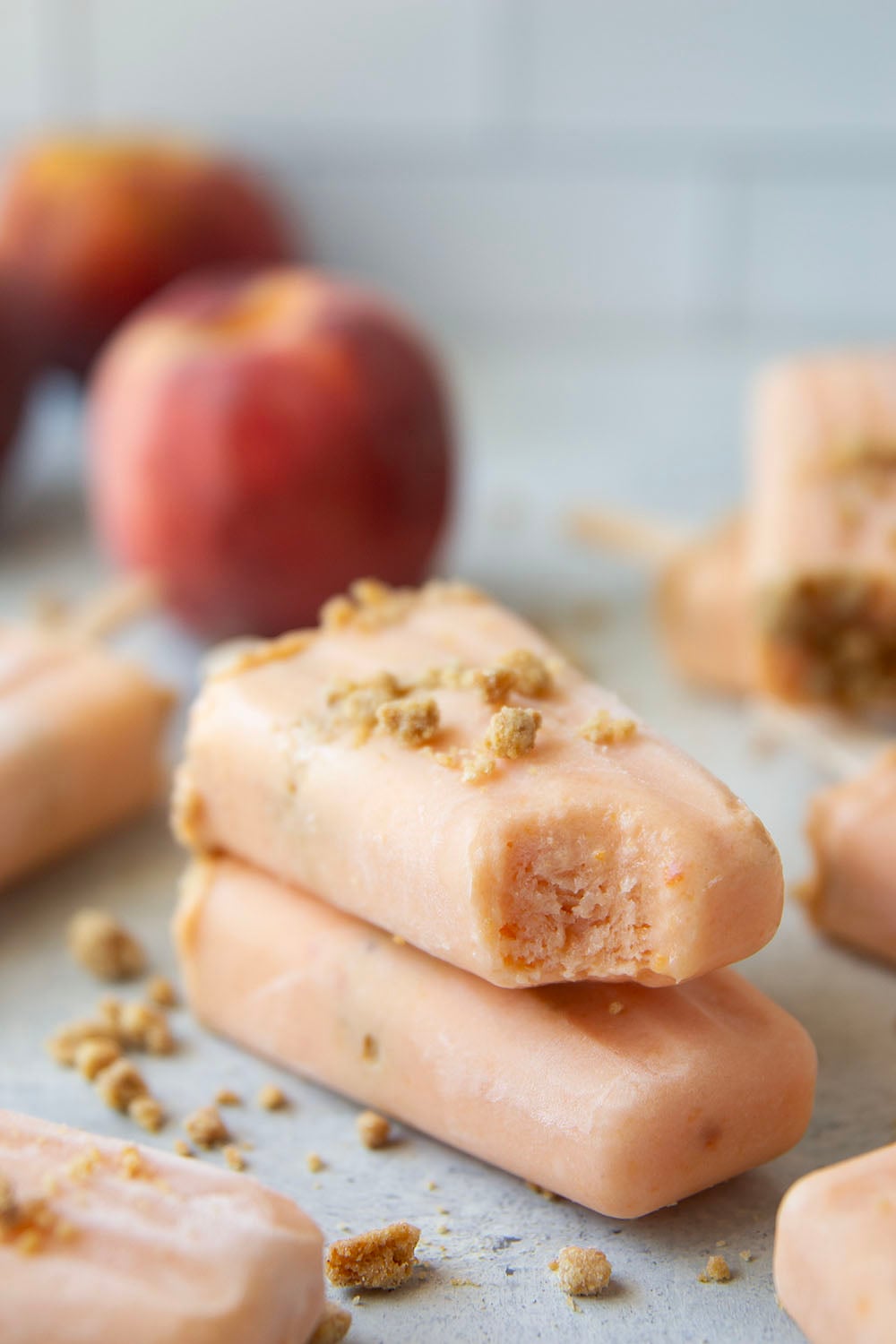 Juicy summer peaches and a crunchy brown sugar streusel are the perfect match in these multi-layered peach popsicles!
