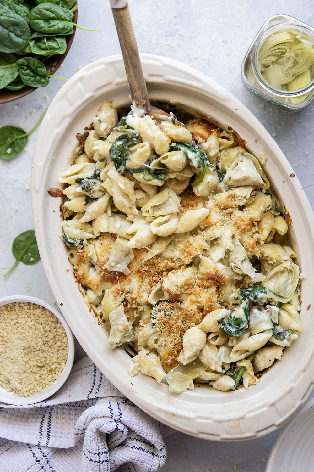 This spinach artichoke mac and cheese combines all the things you love about spinach artichoke dip in one comforting side dish! Packed with two kinds of cheese and lots of tender spinach and artichoke hearts.