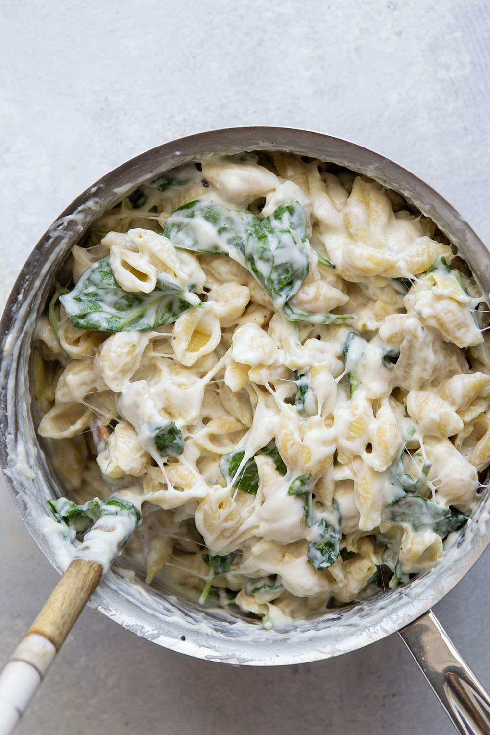 This spinach artichoke mac and cheese combines all the things you love about spinach artichoke dip in one comforting side dish! Packed with two kinds of cheese and lots of tender spinach and artichoke hearts.